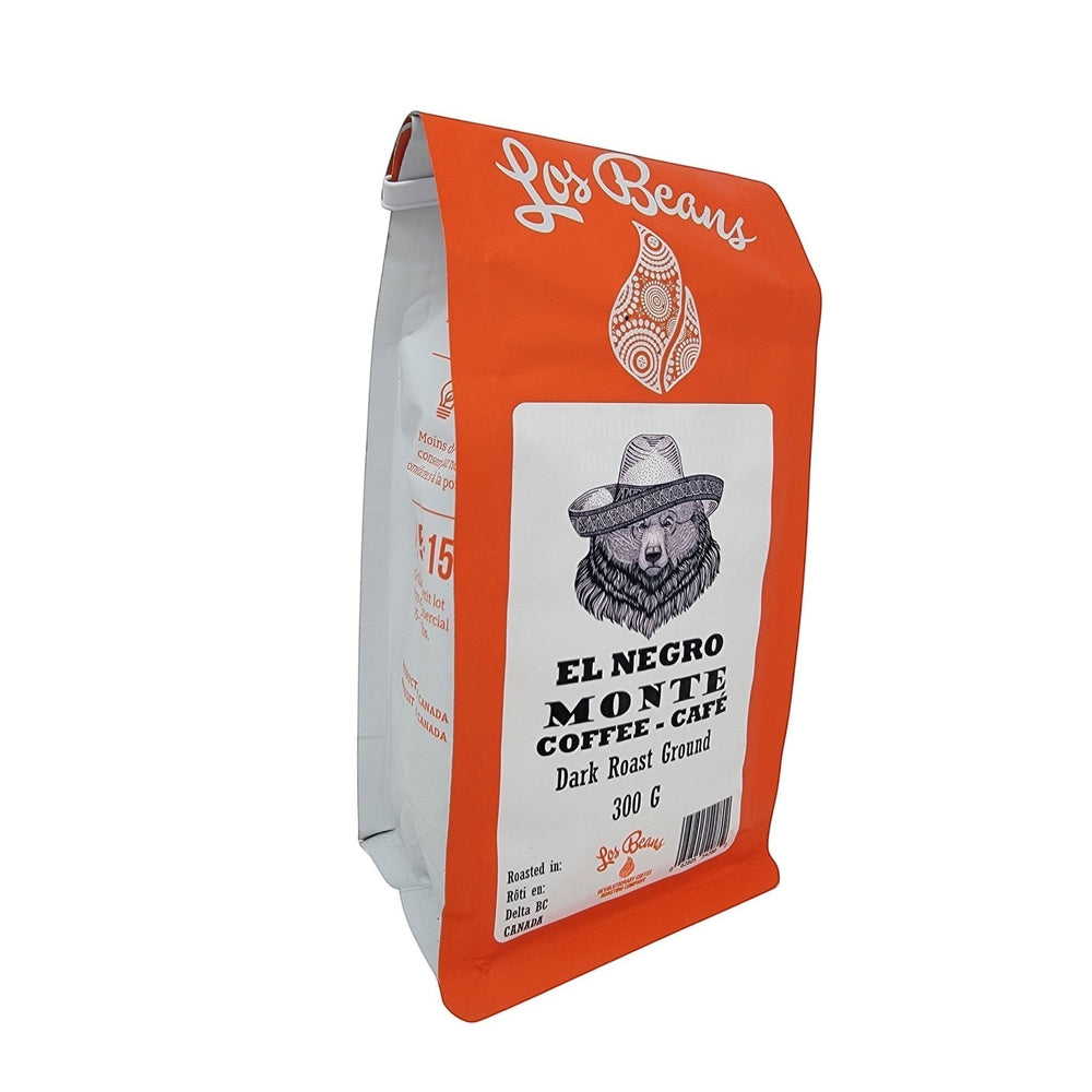 Los Beans El Negro Monte dark roast ground coffee bag with bear graphic and orange packaging.